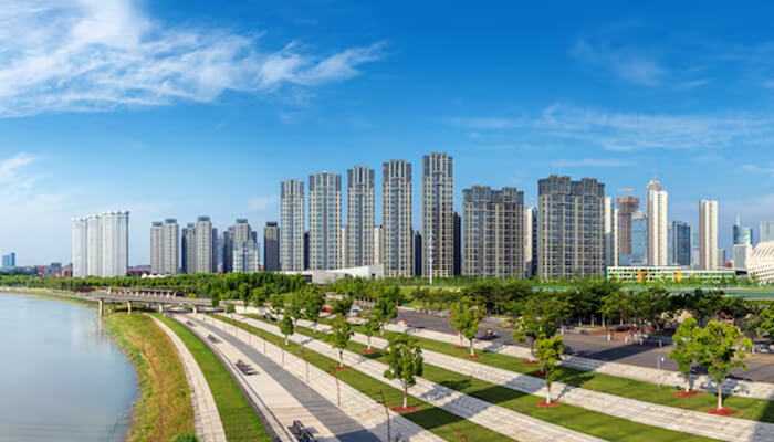 The commercial property landscape | tycoonstory media A panoramic view of modern residential buildings along the river in icheon, south korea, showcasing the city's growing infrastructure and urban development.