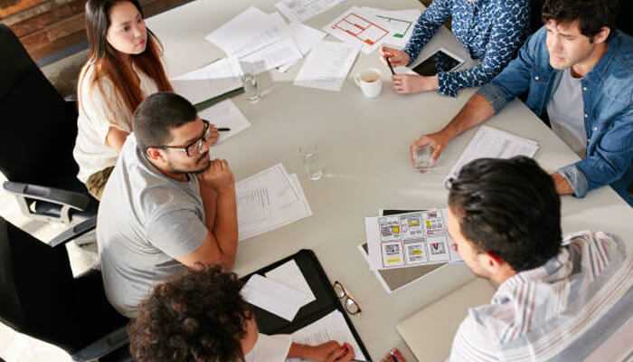 Using an enterprise digital marketing agency is valuable for growth | tycoonstory media Marketing team collaborating on strategy and planning, showcasing the advantage of systemized client acquisition for business growth.