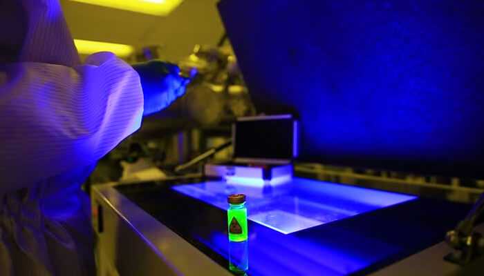 Applications of uv curing | tycoonstory media Uv curing experiment featuring a technician working with specialized equipment to cure coatings, resins, or adhesives under controlled ultraviolet light.