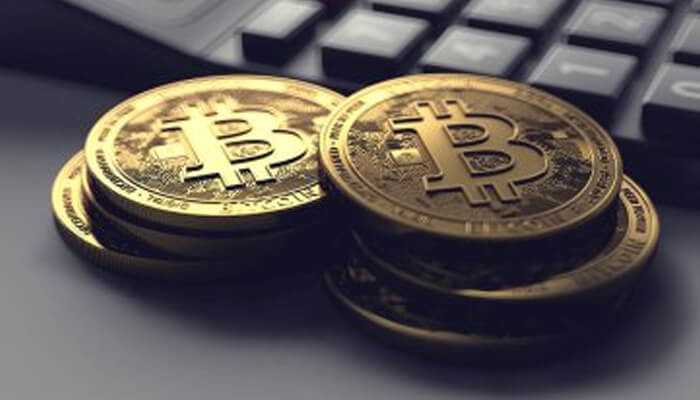 How are fees calculated | tycoonstory media Bitcoin coins stacked next to a calculator, symbolizing the impact of crypto fees on digital currency transactions.