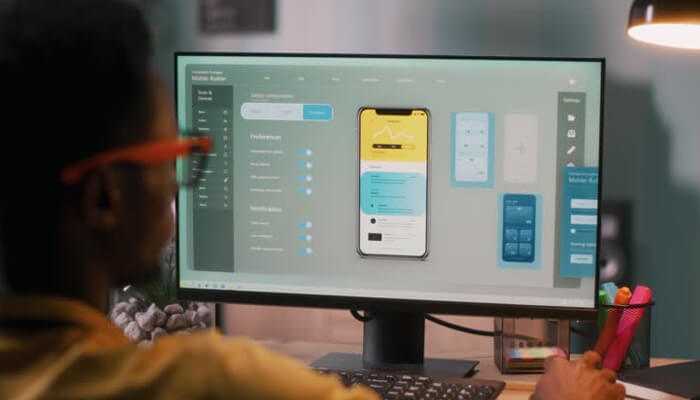 Overlooking platform-specific experience | tycoonstory media Developer working on user interface design after outsourcing mobile app development to a professional team, shown on a desktop screen.