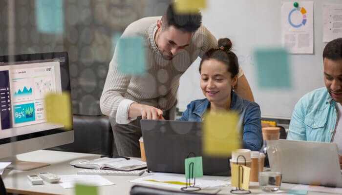 7 key services under one roof | tycoonstory media Kc digital team working on digital marketing and data analytics projects in a collaborative office setup.