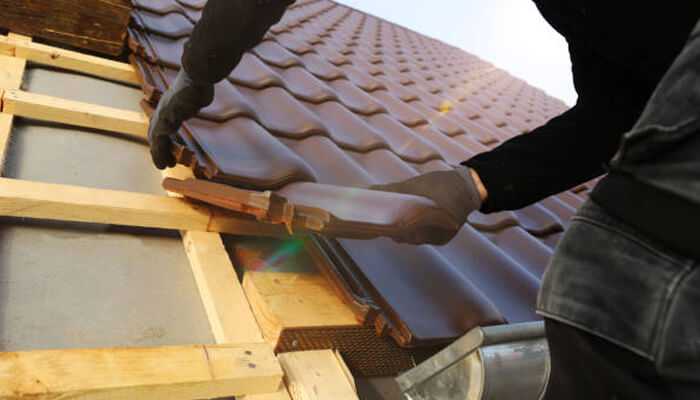 Trades-based startup A worker installing roofing tiles on a house, showcasing the craftsmanship involved in a trades-based startup focused on roofing and construction services.