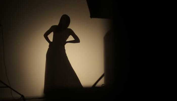 Modeling and acting career 1 | tycoonstory media Pilar sanders net worth: silhouette of a model posing in a studio setting, creating an artistic shadow.