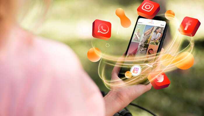 Powerful social media imagery - tycoonstory | tycoonstory media Hand holding phone with glowing social media icons, highlighting visual impact on digital marketing results.