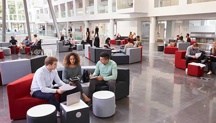 Redesigning event layouts to match executive decision-making styles | tycoonstory media Event planners creating comfortable, collaborative spaces for professional networking and executive engagement during business events.