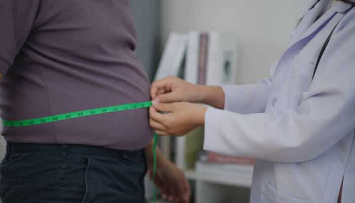 Glp 1 weight loss treatments Doctor measuring a patient's waistline as part of a medical evaluation for GLP 1 Weight Loss Treatments to manage obesity and improve health outcomes.