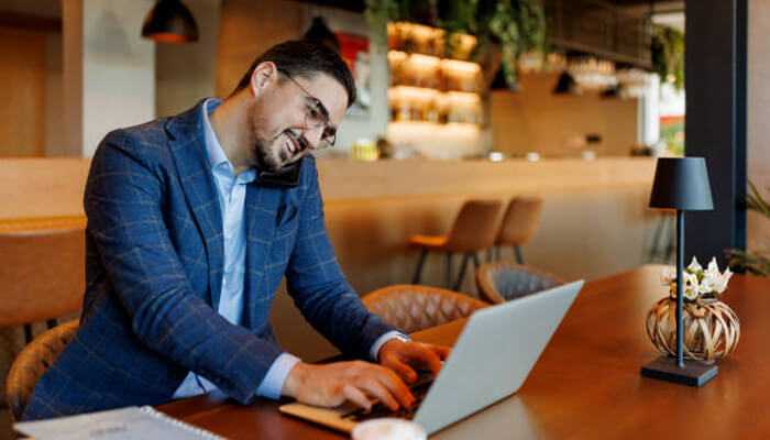 Work without borders | tycoonstory media Digital nomads working from a modern café, embodying the remote work lifestyle with flexible hours and the freedom to work from anywhere.