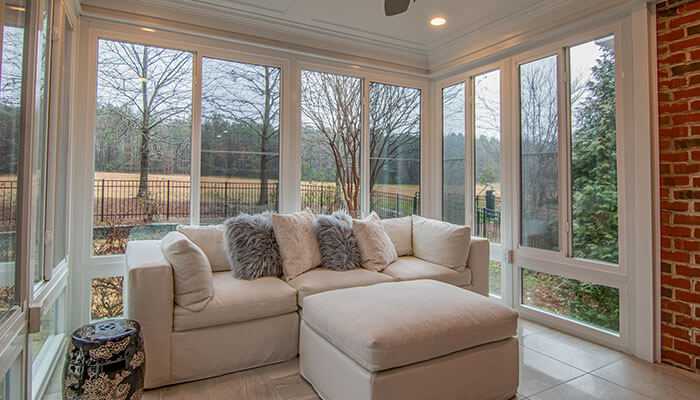 Benefits of choosing energy-efficient window options - tycoonstory | tycoonstory media Bright and airy living space filled with greenery and large windows for ventilation, allowing fresh air and sunlight to enhance indoor comfort.