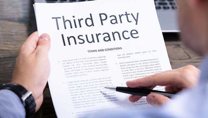 Comprehensive vs third-party car insurance - tycoonstory | tycoonstory media Close-up of a person reading the terms and conditions of third-party car insurance, highlighting the difference in coverage compared to comprehensive insurance.
