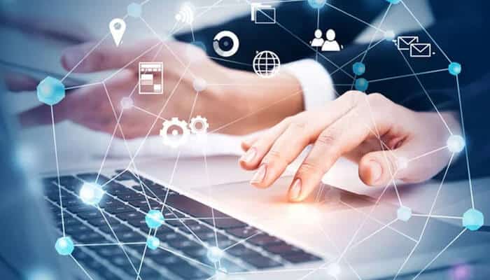 How to choose a provider - tycoonstory | tycoonstory media Close-up of hands typing on a laptop with digital connections and technology icons, representing the role of backlinks in online networking and seo.