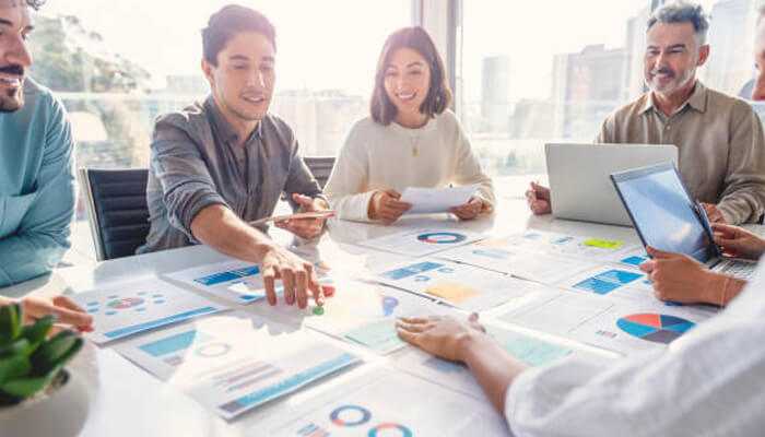 Marketing strategies | tycoonstory media Team discussing strategies and analyzing charts for igaming affiliate marketing campaign.