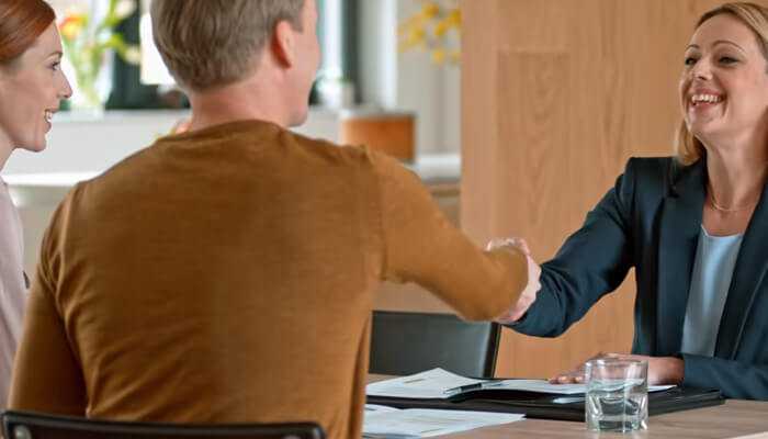 Embedded banking Business partners finalizing a deal with a financial advisor discussing embedded banking for startups solutions