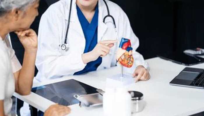 Cardiac tamponade Doctor explaining cardiac tamponade condition using a heart model to a patient