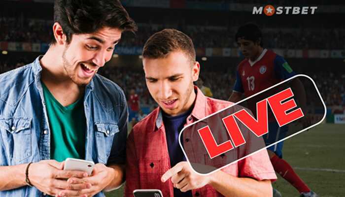 Types of bets that are convenient for live betting | tycoonstory media Two users excitedly placing live bets on the mostbet app during a football match.