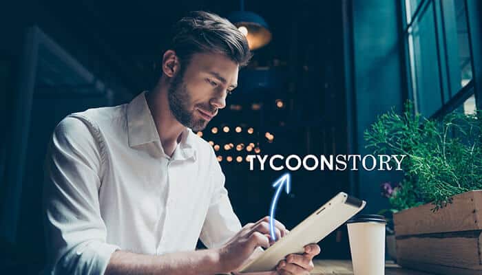 Why choose tycoonstory com - tycoonstory | tycoonstory media A man using a tablet in a modern workspace, with the'TYCOONSTORY' logo, highlighting new learning experiences.