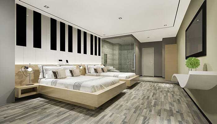 Actionable insights for planning your luxurious group stay - tycoonstory | tycoonstory media A sleek, contemporary bedroom with twin beds, minimalist design, and stylish décor, reflecting the modern luxurious bedrooms of a premier irish estate.