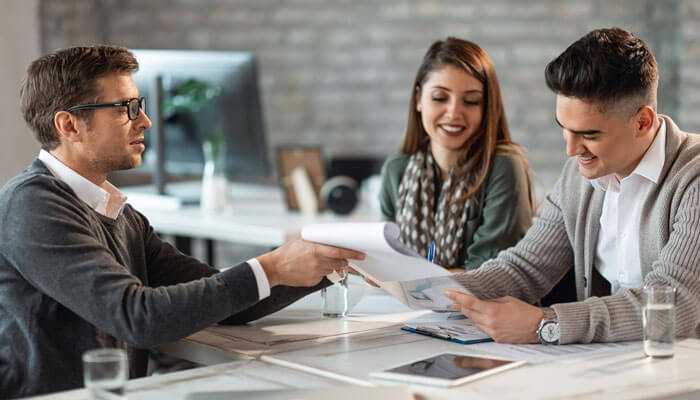 Choosing the right type of lender - tycoonstory | tycoonstory media Business loan consultation with startup founders reviewing documents with a financial advisor – best small business loan options discussion.