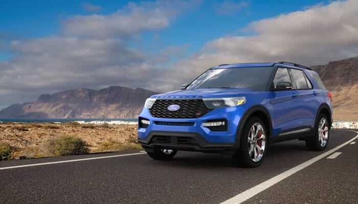 Comparing ford to the competition - tycoonstory | tycoonstory media Blue ford vehicles suv driving on an open road with scenic mountains in the background, highlighting performance and design.