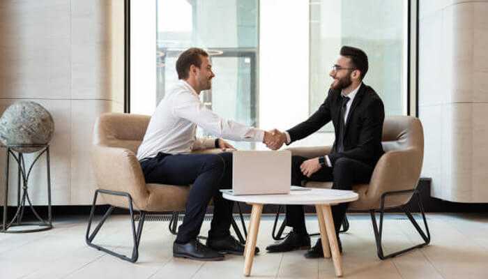 Fake degree or real experience Two businessmen shaking hands during a job interview, highlighting the importance of fake degree or real experience in career opportunities.