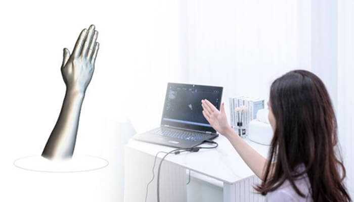 Dual scanning modes for maximum flexibility | tycoonstory media A person holds a handheld scanning device to capture a digital model of a woman standing in front of them. Below the scene, a white banner features the text best 3d face and body scanner" alongside the product name "einstar vega.