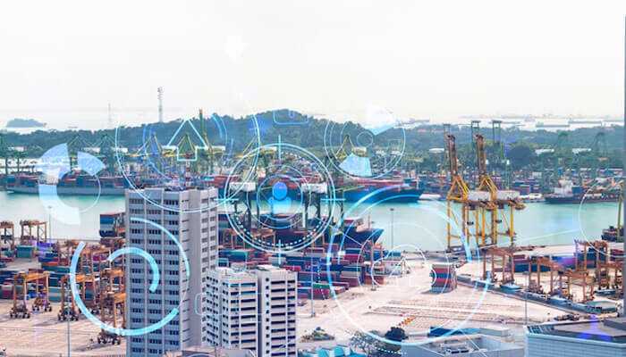 Smart ports with cranes, containers, and digital overlay graphics symbolizing IoT, automation, and data-driven global trade efficiency.