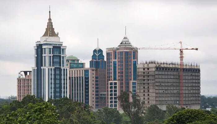 Location and connectivity the real game changer - tycoonstory | tycoonstory media The skyline of new apartments in bangalore with ongoing construction and commercial towers, reflecting rapid real estate growth and development.
