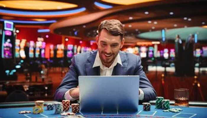 Popular games to play with mrwira8 free credit | tycoonstory media Man enjoying online gaming at mrwira8 free credit casino with poker chips and laptop.