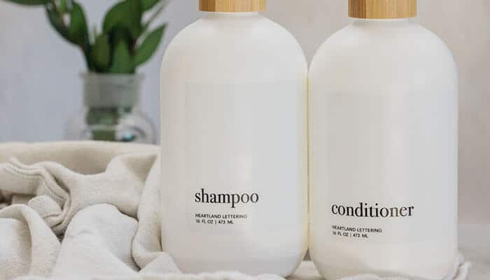 Factors to consider in choosing shampoo and conditioner - tycoonstory | tycoonstory media Minimalist white bottles labeled shampoo and conditioner on a soft towel background — aesthetic packaging for the best shampoo and conditioner set.