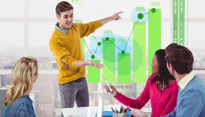 Get the competitive edge - tycoonstory | tycoonstory media Young professional presenting growth statistics to colleagues at a digital marketing agency in dubai.