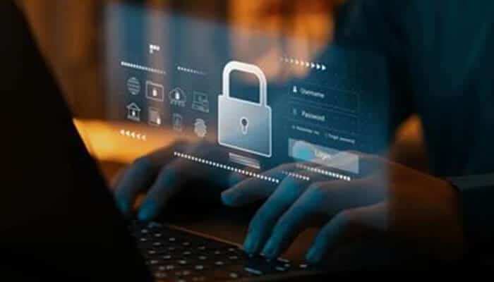Financial security A person typing on a laptop with a digital padlock icon and login interface projected on the screen, symbolizing online protection and financial security in digital transactions.