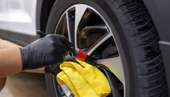 Maintenance habits that keep a daily driver looking premium 1 | tycoonstory media A set of four high-performance car tires standing upright on an asphalt road at sunset, representing necessary maintenance for a reliable daily driver.