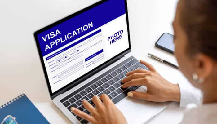 Singapore visa for indians Person filling out an online visa application form on a laptop, representing the process of applying for a singapore visa for indians.