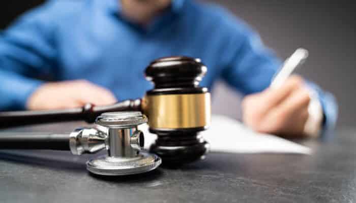 Medical malpractice claims A gavel and stethoscope on a table, representing the intersection of law and medicine in handling medical malpractice claims.