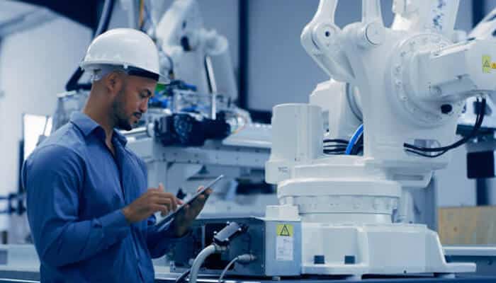 Automation and machine learning integration | tycoonstory media An engineer inspecting robotic automation in a thermoforming facility, reflecting cutting-edge thermoforming innovations for efficiency and precision.