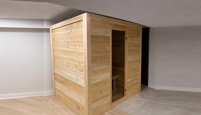 Is installing an indoor sauna a major renovation | tycoonstory media A wooden indoor sauna installed in a spacious room, offering a modern and compact solution for home relaxation.