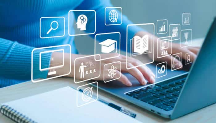 Skills students gain through online engineering programs | tycoonstory media Person typing on a laptop with digital icons representing various educational tools, symbolizing the skills students gain through online engineering degrees.