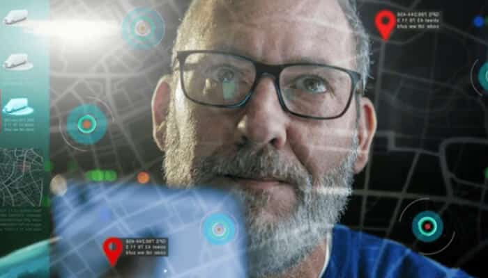 Supporting training safety and skill development | tycoonstory media Close-up of a logistics manager using advanced fleet tracking technology with gps location markers and digital mapping interface for real-time vehicle monitoring.