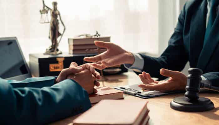 Verbal agreements can still be legally binding | tycoonstory media A lawyer and client discussing legal matters in an office, with a focus on understanding australians rights and ensuring fair representation in legal cases.