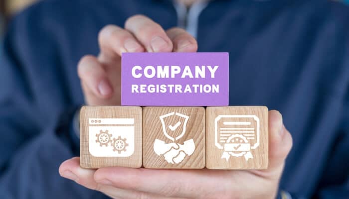 Basic requirements for company registration | tycoonstory media Starting a business in hong kong represented by wooden blocks with icons and a'Company Registration' sign, symbolizing key steps in the registration process.