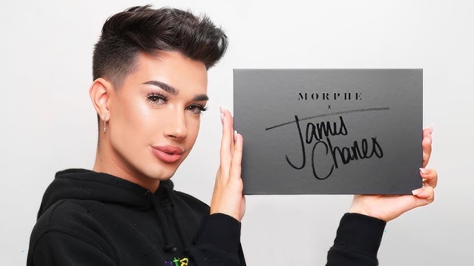 James charles holding his morphe collaboration palette | tycoonstory media James charles holding a morphe palette with his signature. As a beauty influencer, his collaborations have contributed to his impressive james charles net worth.