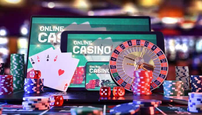 Online | tycoonstory media Squeen668 online casino: a laptop and tablet displaying the'ONLINE CASINO' screen, surrounded by playing cards, roulette wheel, dice, and poker chips, showcasing the exciting world of online gaming.