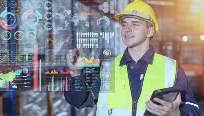 Where mro data is stored and how it becomes fragmented | tycoonstory media A worker interacts with a digital dashboard, showcasing mro data for operational analysis.