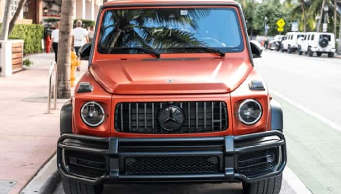 Why collectors value vintage g wagons | tycoonstory media The image shows a modern orange mercedes g-wagon, known for its iconic design and luxury features, highly valued by collectors, especially those interested in vintage g wagons