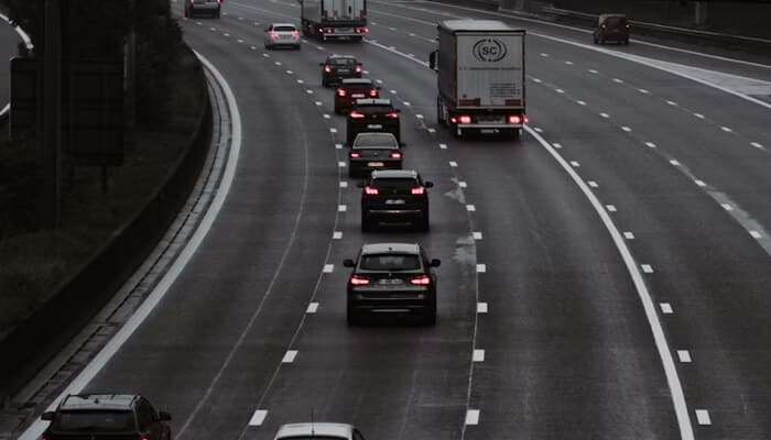 Why rebuilds create lasting know-how | tycoonstory media Vehicles traveling along a multi-lane highway, illustrating real-world testing and experience gained during the car rebuild process.