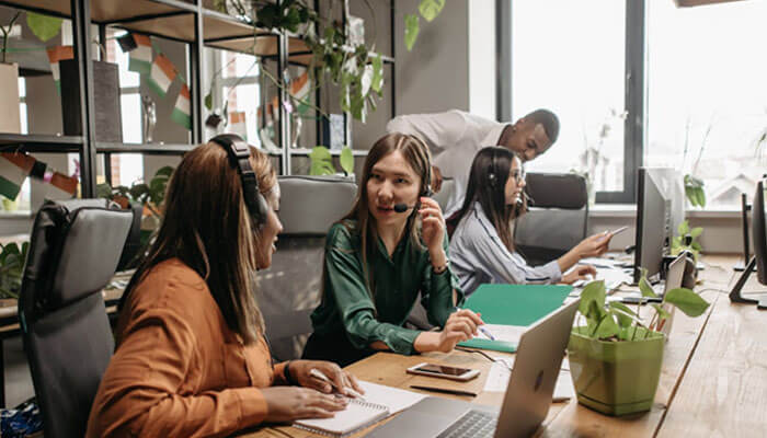 24/7 support can transform your business operations | tycoonstory media Team collaborating in an office, providing 24/7 support and seamless customer service.