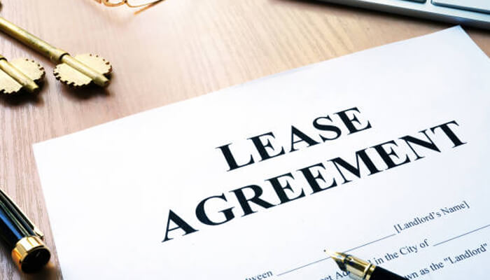 Drafting the lease agreement | tycoonstory media An image of a lease agreement document on a desk with a pen, symbolizing the process of drafting aircraft leasing agreements for aviation businesses and operators.