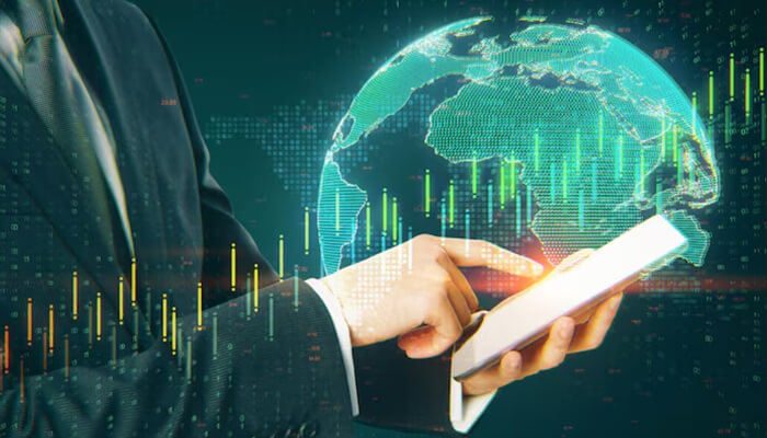 Easy ways to invest globally | tycoonstory media Business professional using a tablet and global market data, representing building a global portfolio through smart international investment planning.