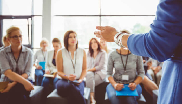 Great learning academy | tycoonstory media A person leading a session with an engaged audience. This setting emphasizes the value of human resource courses for developing key hr skills and professional growth.