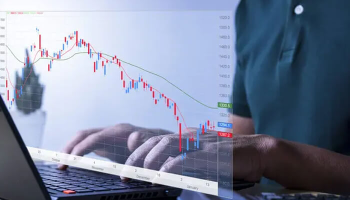 How do futures markets impact investment strategies | tycoonstory media An individual analyzing a financial chart on a laptop, representing investment strategies and market analysis, much like the approach used by financial experts such as lucas birdsall.